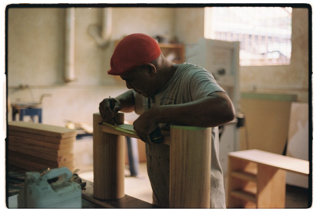 Small-batch designer concrete and wood furniture production, crafted by artisans detailing each piece by hand.