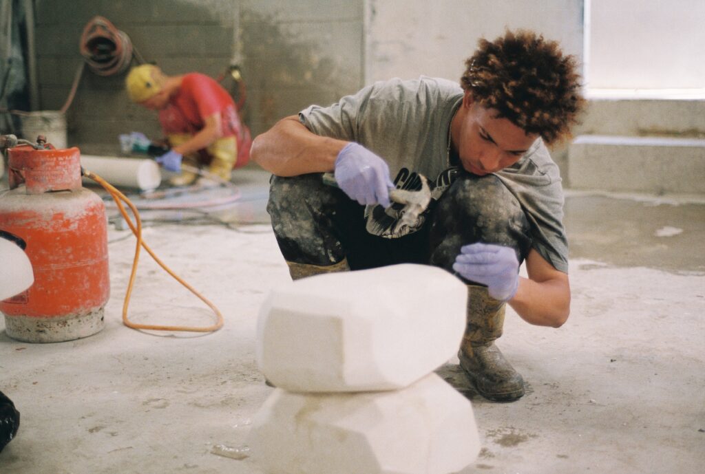 Artisans handcrafting small-batch concrete furniture with detailed finishing in a Dominican Republic workshop.