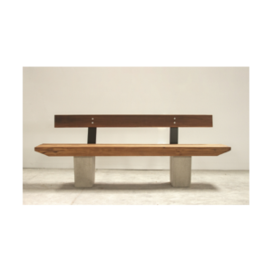 Banco B wooden bench by Gola Home, featuring diagonally cut wood slats, concrete block legs, and a wood backrest with metal supports, handcrafted in the Dominican Republic.