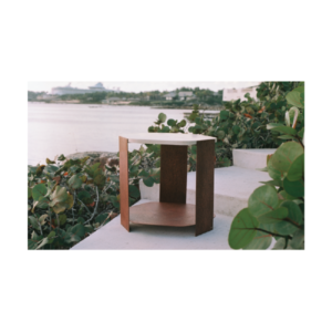 Ferro side table with hexagonal oxidized metal base in a bronze-orange tone and a beige concrete top with dark veining, sculptural statement table measuring 66 x 61 x 61 cm.