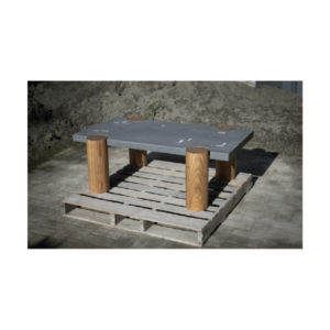 CACIQUE coffee table with a rectangular concrete top inlaid with white concrete and bronze elements, supported by four solid Caribbean hardwood pillars.