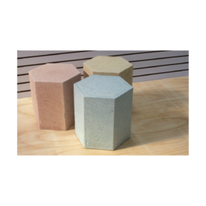 Hexagonal concrete ottoman in solid concrete available in various colors, multifunctional indoor and outdoor seating and side table.