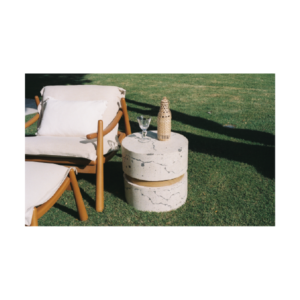 Yunta ottoman with stacked round veined concrete discs resembling marble and a central natural wood insert, outdoor furniture for Caribbean residential and commercial projects.