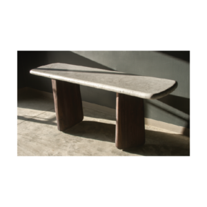 Organic console table with asymmetrical burnt wood legs and a rectangular polished concrete top with curved edges, perfect for modern interiors.