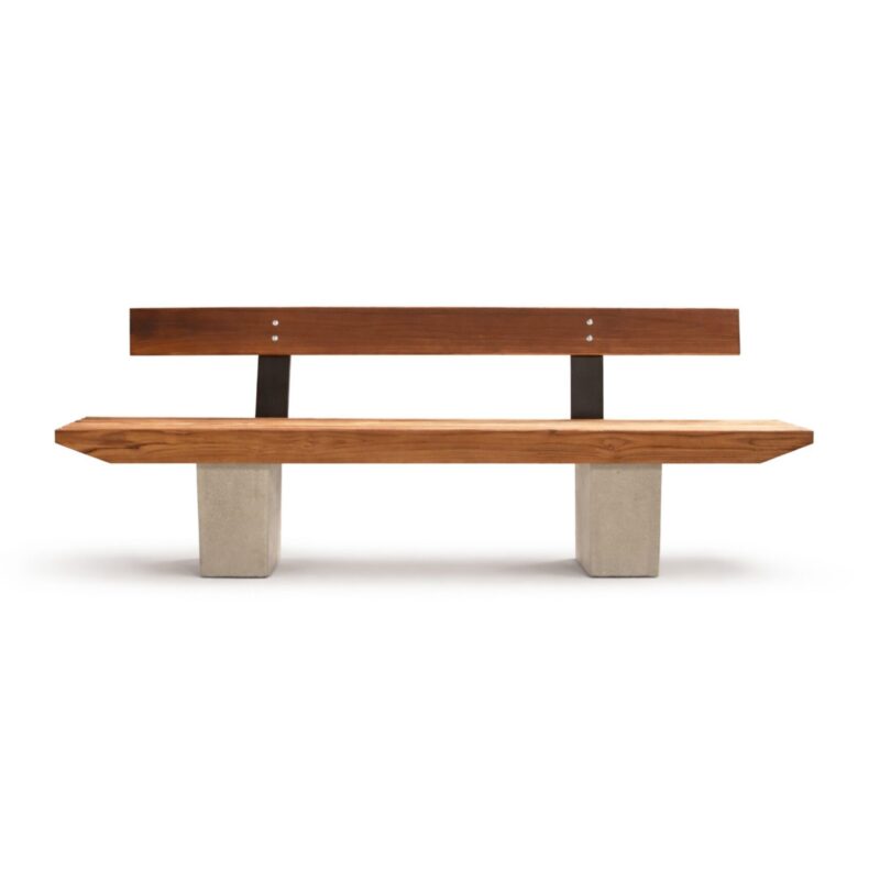Banco B wooden bench by Gola Home, featuring diagonally cut wood slats, concrete block legs, and a wood backrest with metal supports, handcrafted in the Dominican Republic.