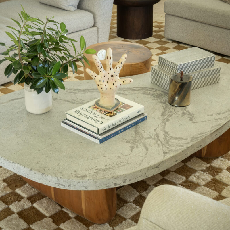 Organic coffee table by Gola Home with irregular curved concrete top featuring natural veining and a solid wood base, handcrafted in the Dominican Republic.