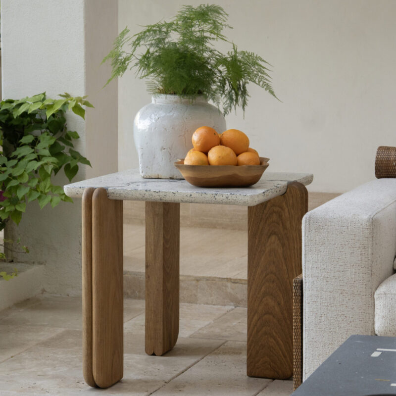 Peninsula side table measuring 61 x 61 x 61 cm with a white concrete top featuring subtle slate-toned veining, supported by three solid rosewood pillars.
