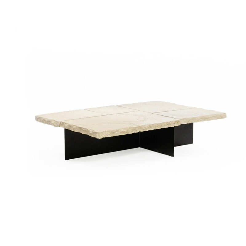 Raw white concrete coffee table with rock-like unpolished edges, separated slab top, and thin black iron base.