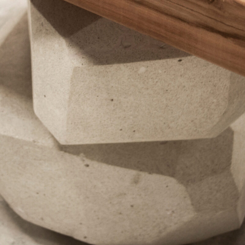 Piedra Bench by Gola Home, sculptural concrete furniture from the Dominican Republic with white concrete stone forms and a solid wood slab seat.