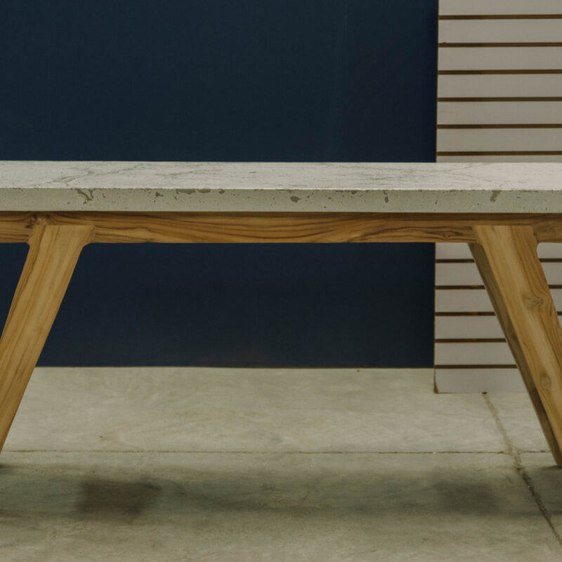 Modern concrete and wood M console table, clean lines and minimalistic design for indoors and outdoor spaces.